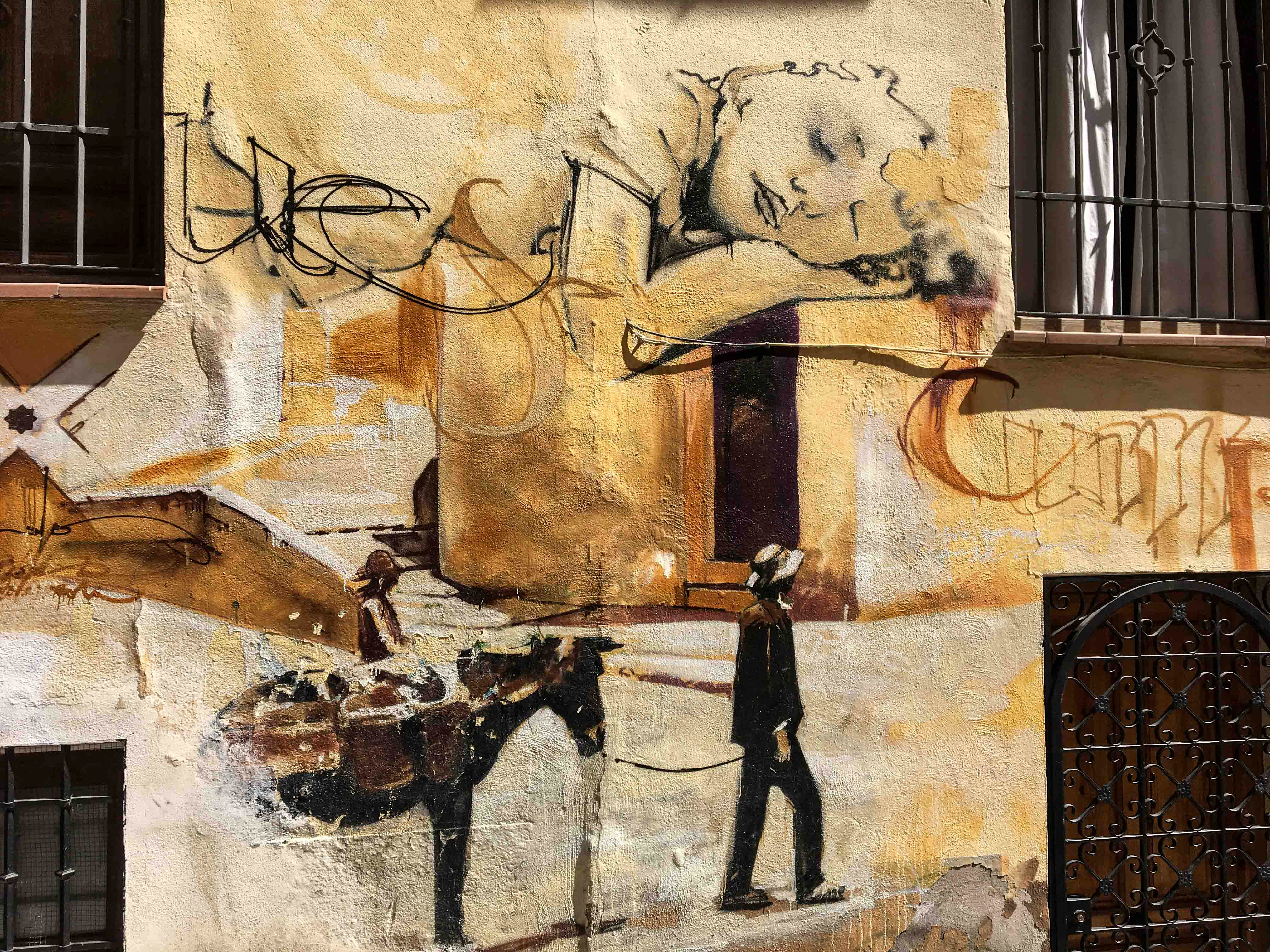 Ausschnitt aus einem Mural von El Niño de las Pinturas dass ein schlafendes Kind und einen Mann mit einem Esel zeigt